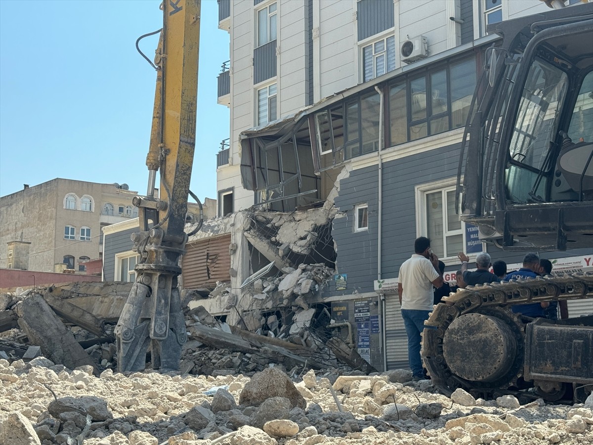 Şanlıurfa'da, Kahramanmaraş merkezli depremlerde ağır hasar gören 5 katlı binanın yıkımı sırasında...