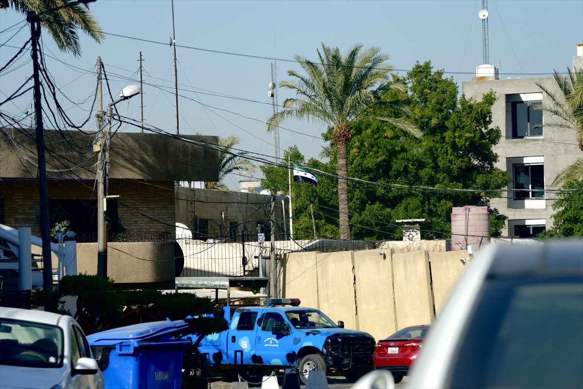 Suriye'nin Bağdat Büyükelçiliğinde, çöken Baas rejimine ait bayrağın yerine "Suriye devrimi...